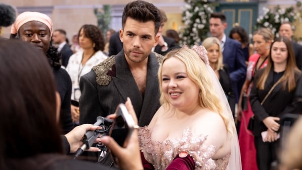 Luke Newton and Nicola Coughlan talk on the red carpet in London on Tuesday night