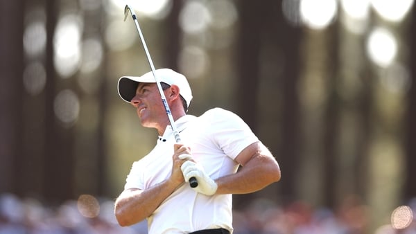 Rory McIlroy plays an approach shot from the 16th fairway during his second round