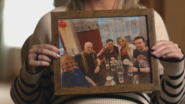 Martin Lynn's sister Sharon holds up a photo of Martin (right) with his family. Martin Lynn died following a one-punch attack last summer