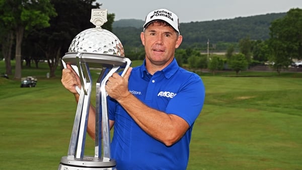 Harrington holds the trophy for the third year in succession after winning the final round