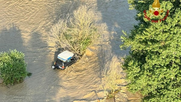 A family had to be rescued from a car stuck in a flooded river in the Piedmont region of Italy (Image: Italian Fire Service)