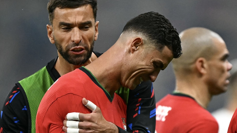 Ronaldo is comforted by team-mate Rui Patricio after missing his extra-time penalty against Slovenia