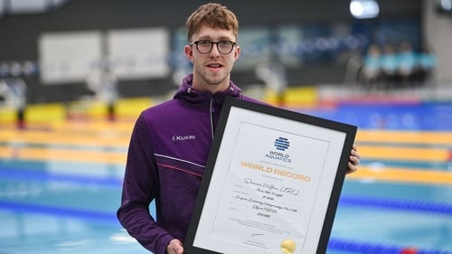 Daniel Wiffen with a certificate marking his world record in the 800m freestyle