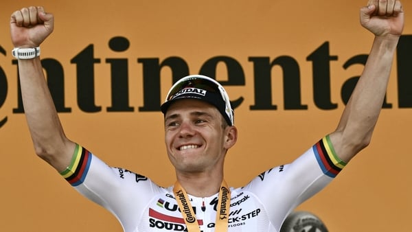 Remco Evenepoel celebrates on the podium after winning the seventh stage