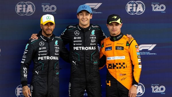 George Russell (C), Lewis Hamilton (L) and Lando Norris pose together after qualifying