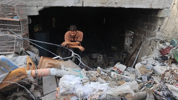 A man checks the damage in a house hit by Israeli bombardment in Zawayda in Gaza