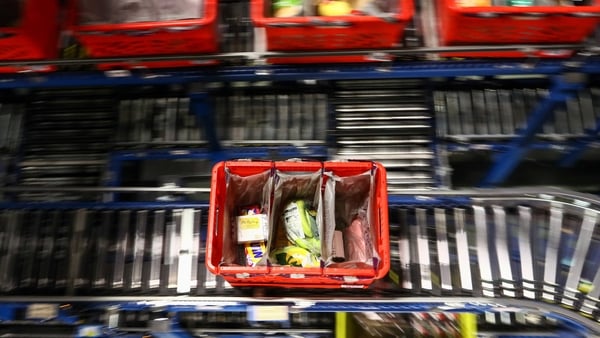 Ocado has reported a lower first half loss and raised its financial guidance for the full year