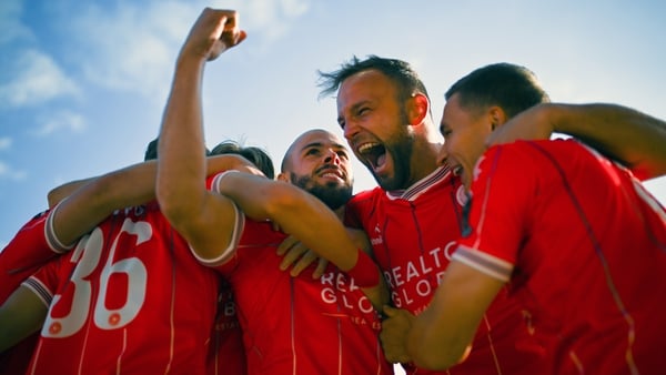 Shelbourne's Mark Coyle, centre, celebrates with team-mates, including Paddy Barrett, right, after scoring in the opening minute against St Joseph's