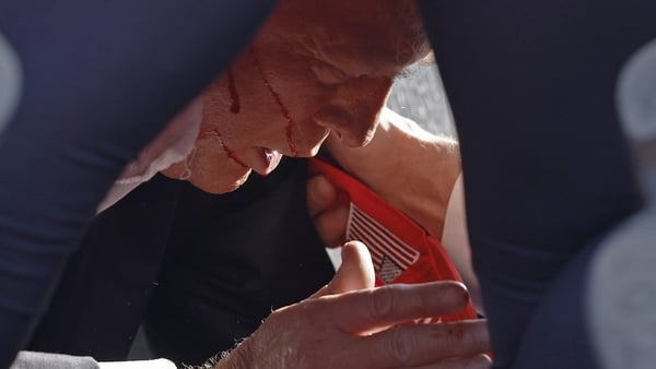 Donald Trump is seen on the ground with blood on his face moments after he was shot