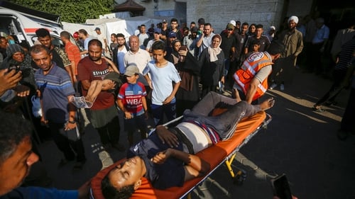 Injured Palestinian children are brought to al-Aqsa Martyrs Hospital following a strike on a school in Gaza