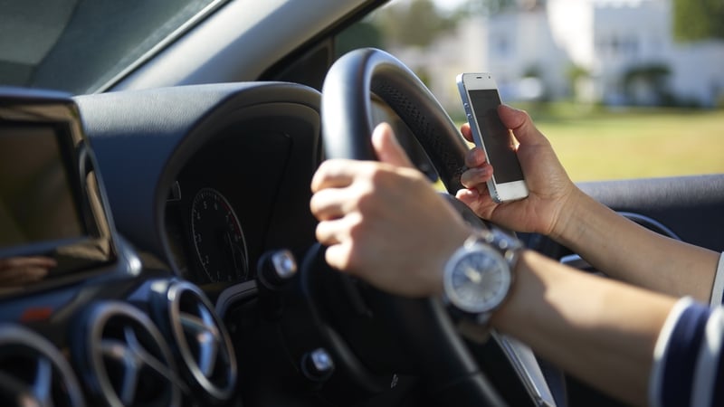 Road safety warning as motorists checking apps when driving