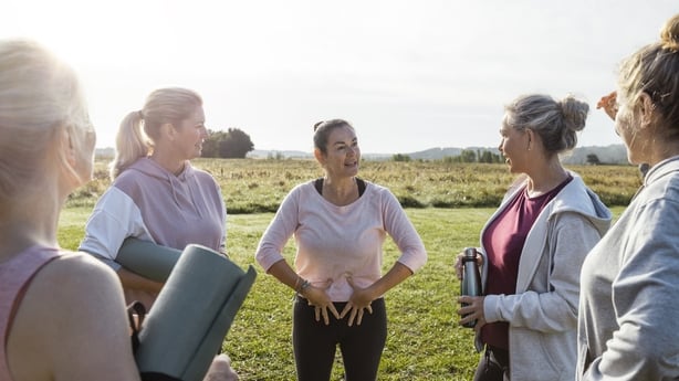 Group of mature women doing Yoga outdoors