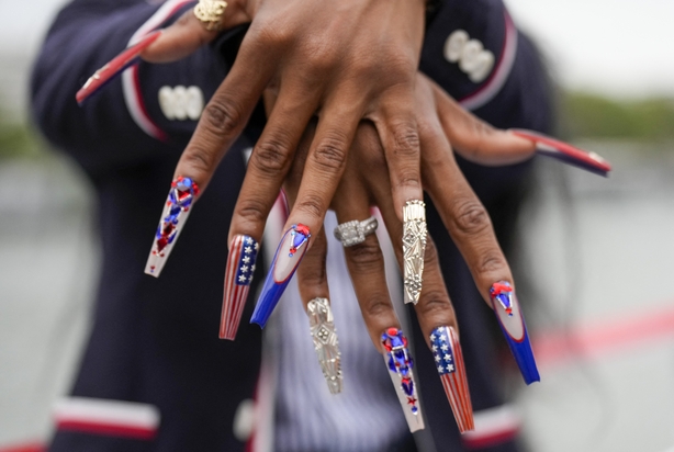 Sha Carri Richardson of the United States shows off her nails while traveling along the Seine River during the opening ceremony of the 2024 Summer Olympics