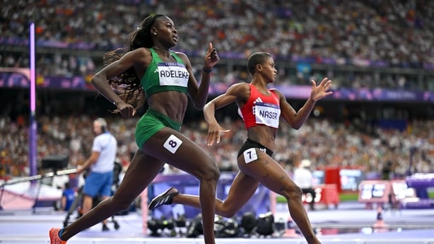 Women's runners cross the finish line with a range of hairstyles