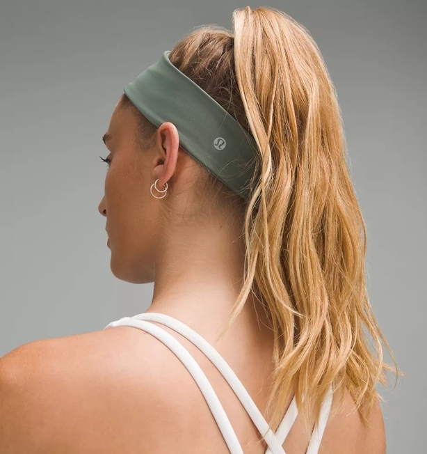 Woman wears green sports headband on head