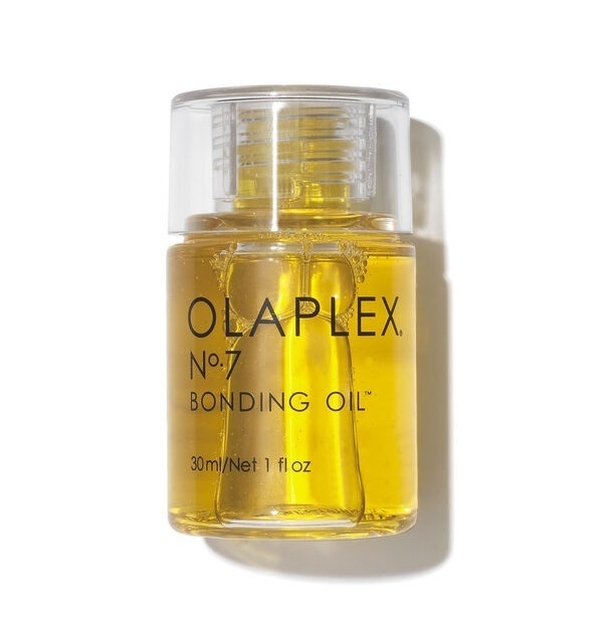 See-through plastic bottle of nourishing hair oil