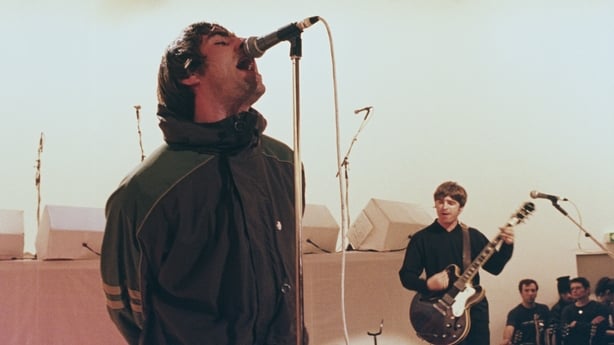 Singer Liam Gallagher (left) and his brother, guitarist Noel Gallagher, performing with British rock band Oasis on Channel 4's live music TV show 'The White Room', 26th January 1996.