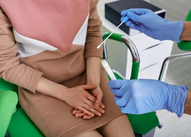 Woman sat in a GP's clinic about to get a smear test