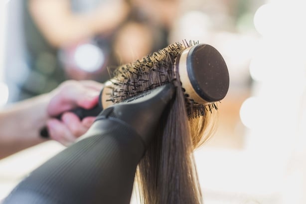 Hairdryer and barrel brush drying hair