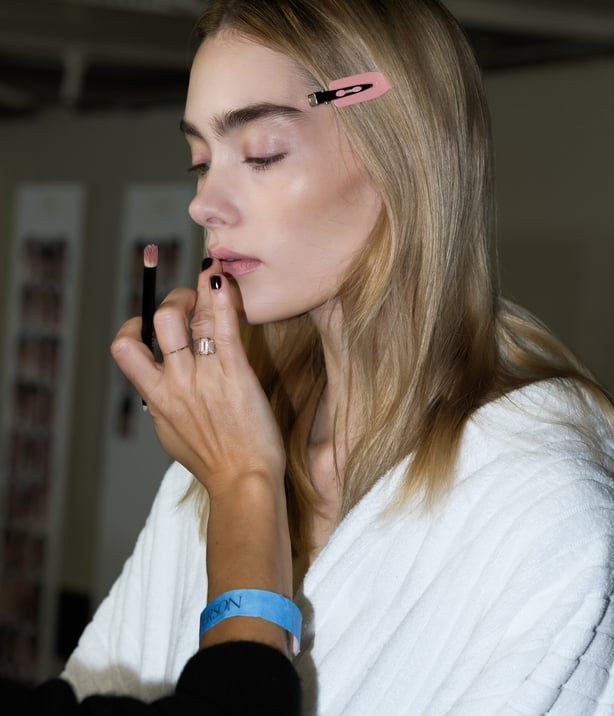 A model backstage at the JW Anderson show