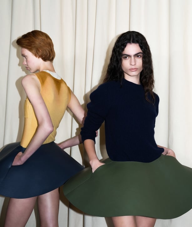 Models pose in khaki and navy dresses