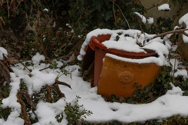 A cracked terracotta pot in winter (Alamy/PA)