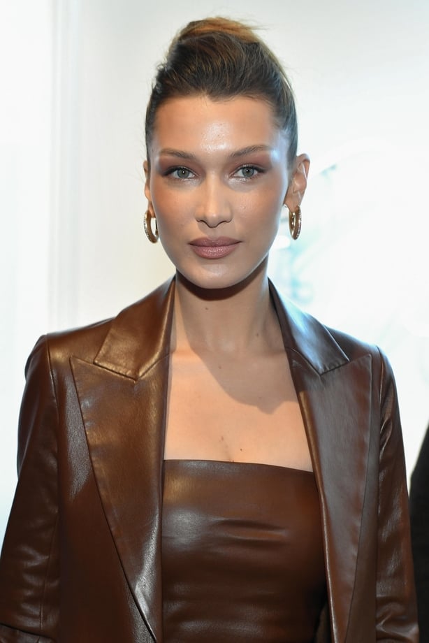 Bella Hadid smiles in bun up do