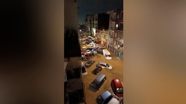 Cars float down street into pile-up as severe flooding hits Valencia