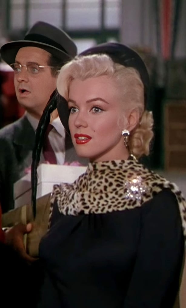 Marilyn wears leopard print scarf and black dress
