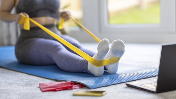 Young athlete doing exercises with a resistance band