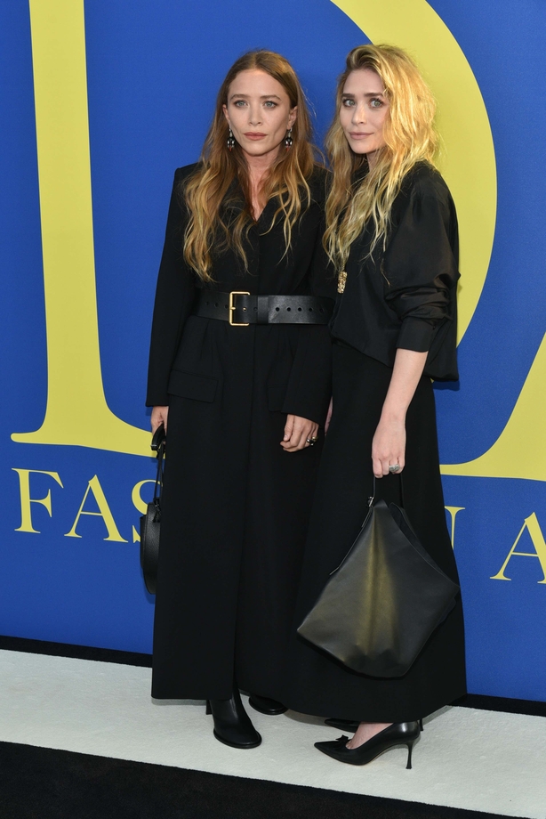 Mary-Kate and Ashley Olsen stand in all black at the Fashion Awards 2018
