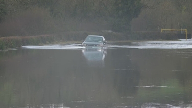 Cars drive through flooded Donegal road