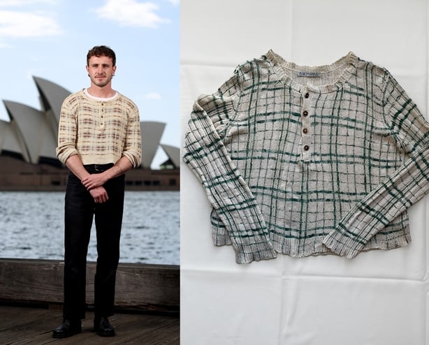 Paul poses outside Sydney Opera House in silk cardigan