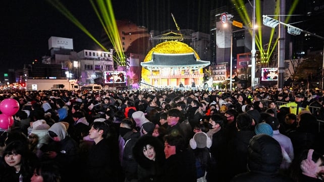 People gather during 2025 New Year's Day celebrations, post midnight at the Bosingak pavilion in central Seoul, South Korea