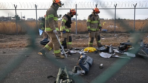 Recovery teams work at the crash scene at Muan International Airport