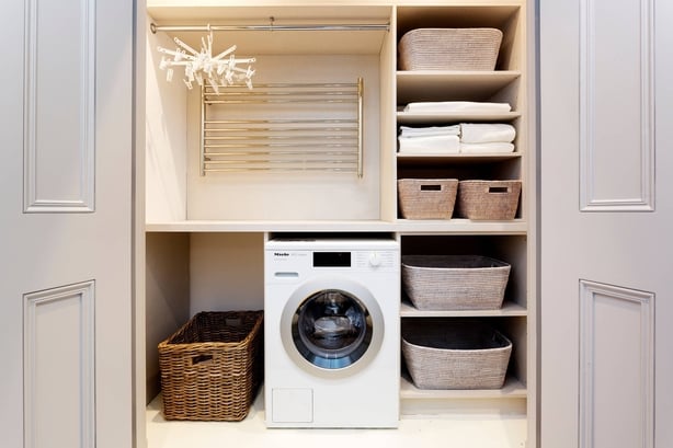This tucked away utility space has ample storage and can be conveniently accessed and concealed when necessary 