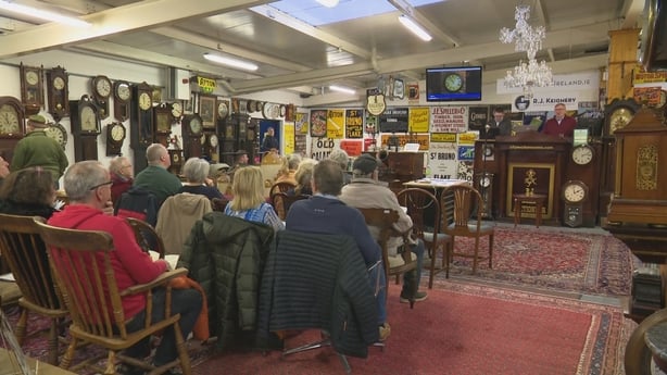 The auction includes grandfather clocks, wall and mantel clocks, and pocket watches