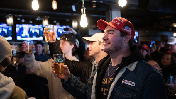 Jake Porter, of Orange County, Calif., watches the second inauguration of President Donald Trump at Union Pub on Capitol Hill