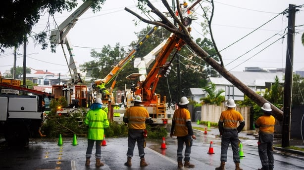 Energex crews clear a fallen tree following the passage of tropical cyclone Alfred in Brisbane on March 8