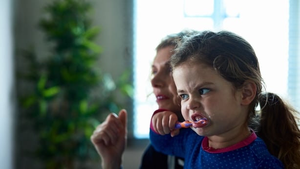 Little girl brushing her teeth