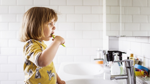 Small girl (2-3) brushing teeth