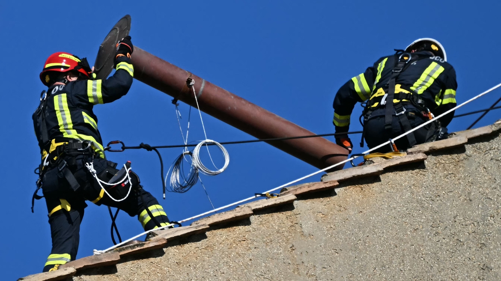 Workers install chimney atop Sistine Chapel for conclave