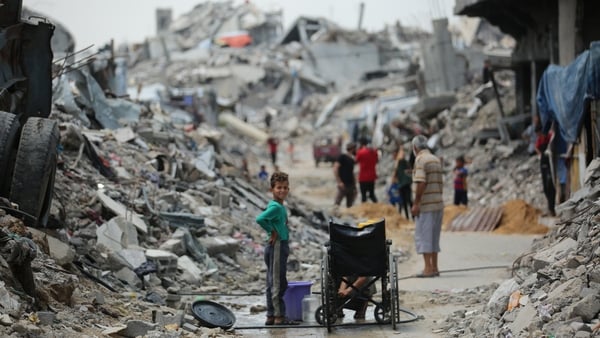 Displaced Gazans are pictured amid the rubble of destroyed buildings in Jabalia
